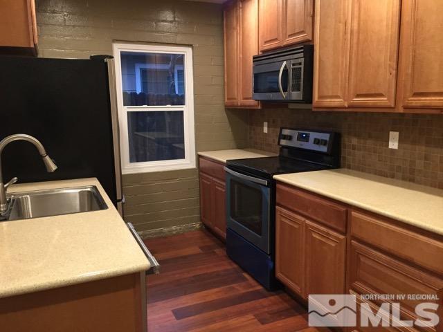 1333 Terrace Drive Reno, NV 89503 - Photo 2 of 21 a kitchen with stainless steel appliances granite countertop a stove a sink and a microwave