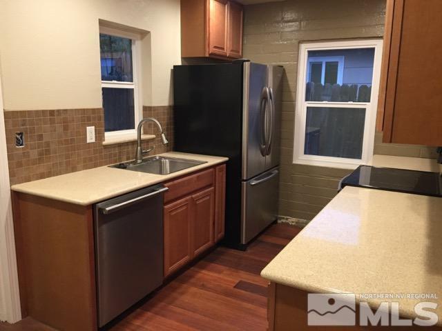 1333 Terrace Drive Reno, NV 89503 - Photo 3 of 21 a kitchen with stainless steel appliances kitchen island granite countertop a refrigerator a stove and a sink