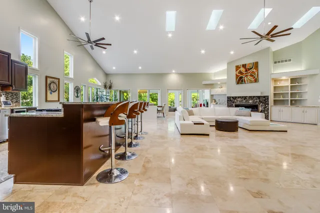 a living room with furniture a flat screen tv and a large window