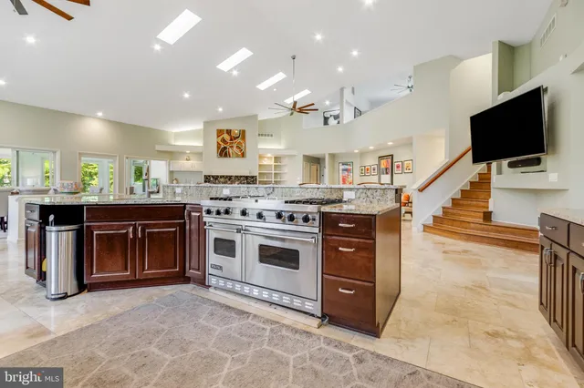 a bedroom with a bed gym equipment and a view of living room