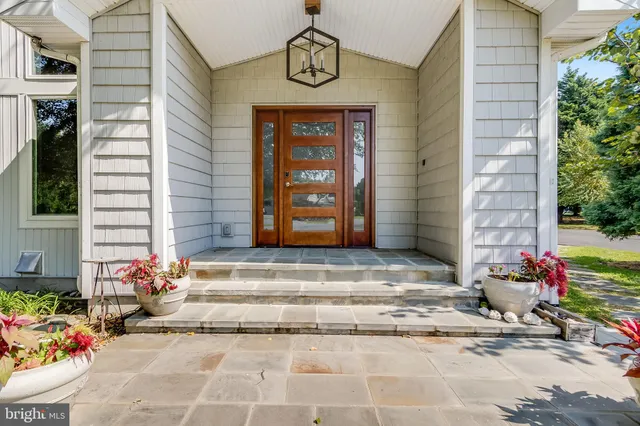 a dining room with furniture and a floor to ceiling window