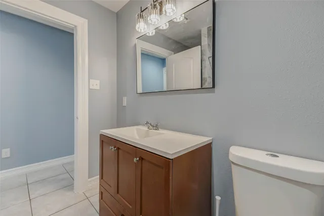 a bathroom with a sink a toilet and mirror