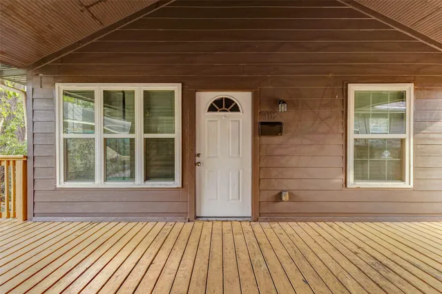 a view of front door of house with wooden floor