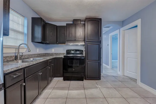 a kitchen with a refrigerator and a sink