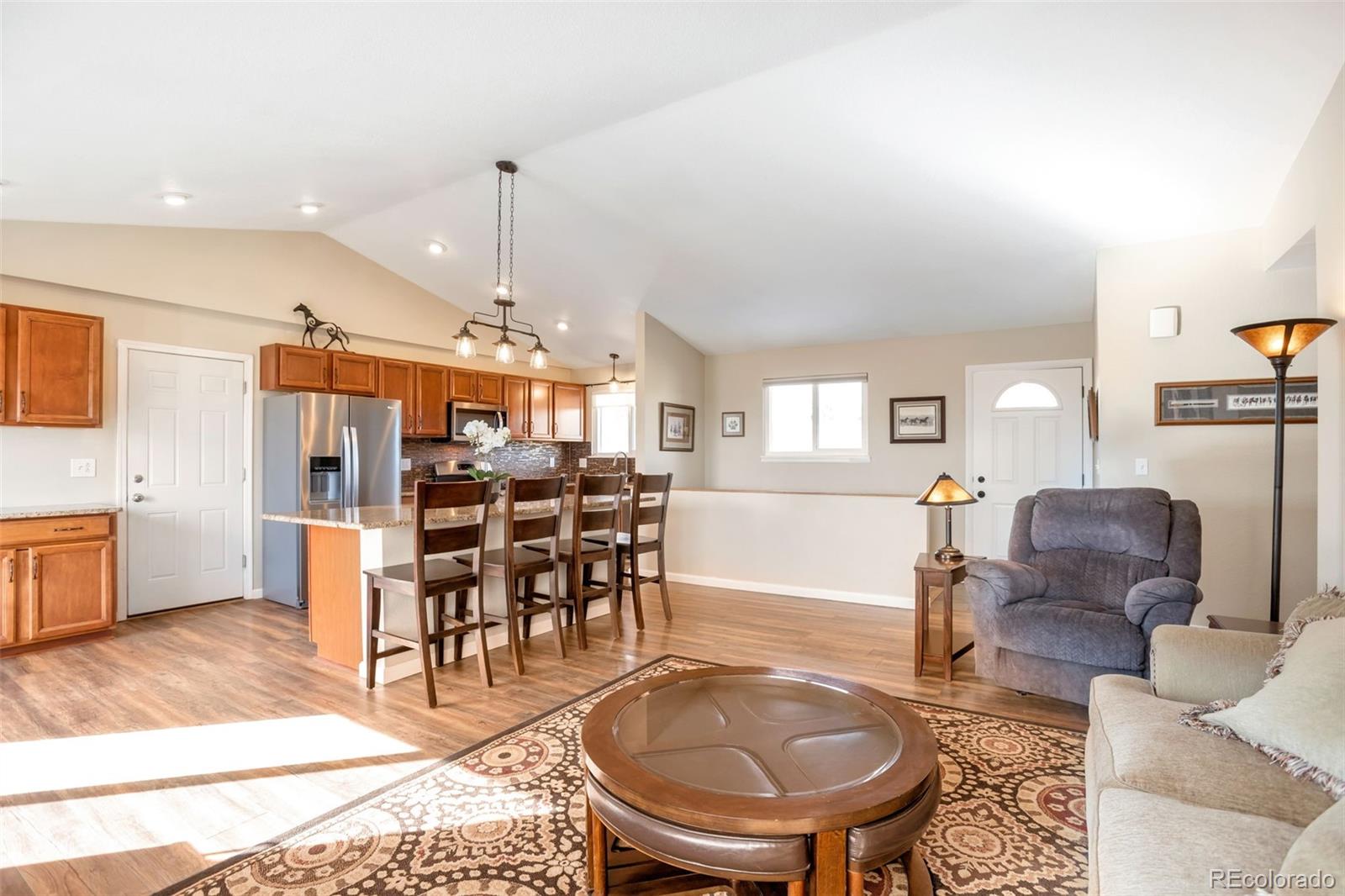 8678 Lariat Loop Elizabeth, CO 80107 - Photo 15 of 50 a living room with furniture a dining table and kitchen view