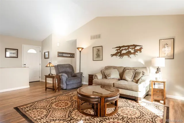 a living room with furniture and a rug