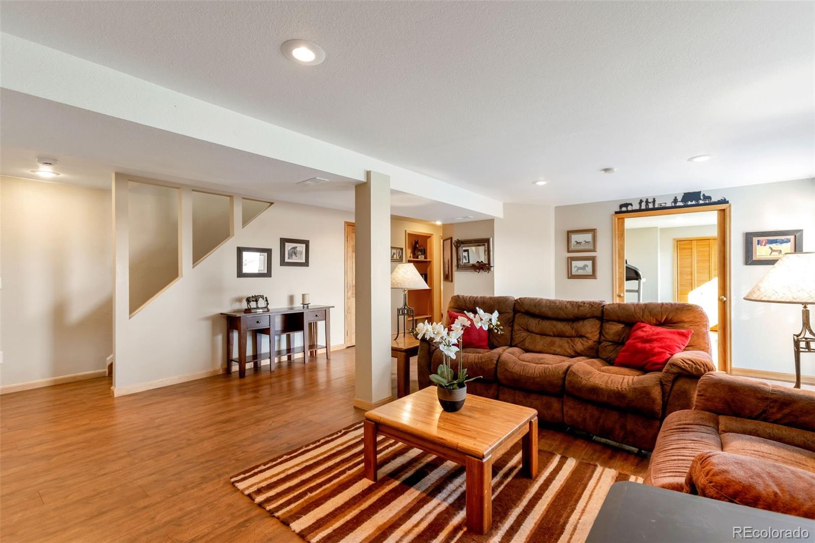 8678 Lariat Loop Elizabeth, CO 80107 - Photo 18 of 50 a living room with furniture and wooden floor