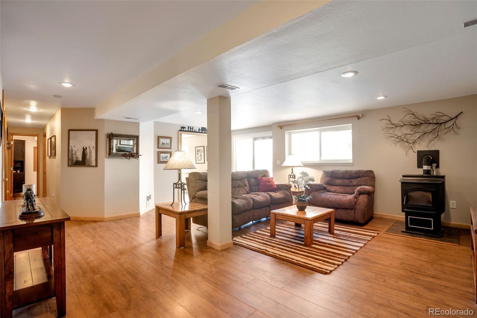 8678 Lariat Loop Elizabeth, CO 80107 - Photo 20 of 50 a living room with furniture and wooden floor