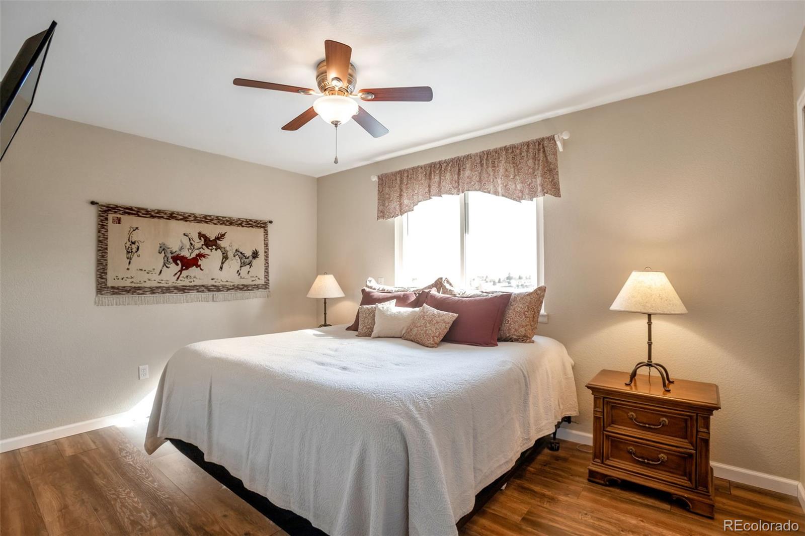 8678 Lariat Loop Elizabeth, CO 80107 - Photo 23 of 50 a bedroom with bed and a chandelier