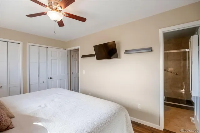 a bedroom with a bed and a ceiling fan