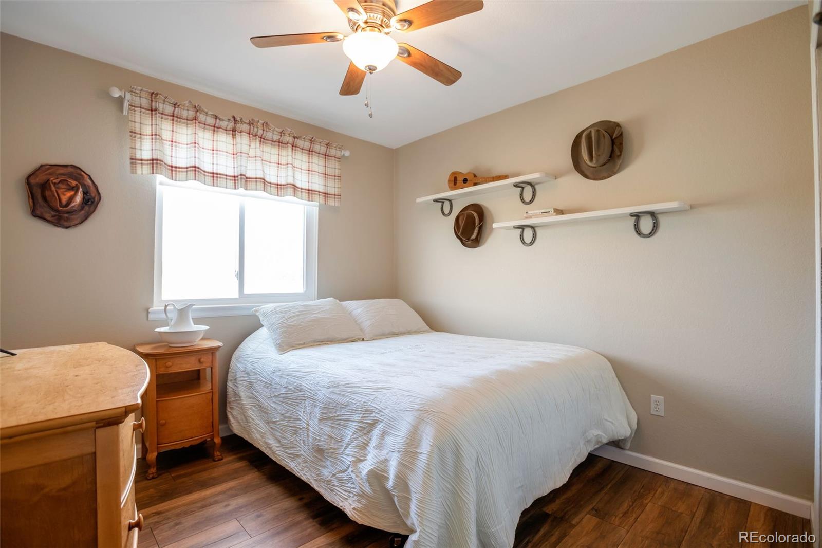 8678 Lariat Loop Elizabeth, CO 80107 - Photo 26 of 50 a bedroom with a bed and a chandelier