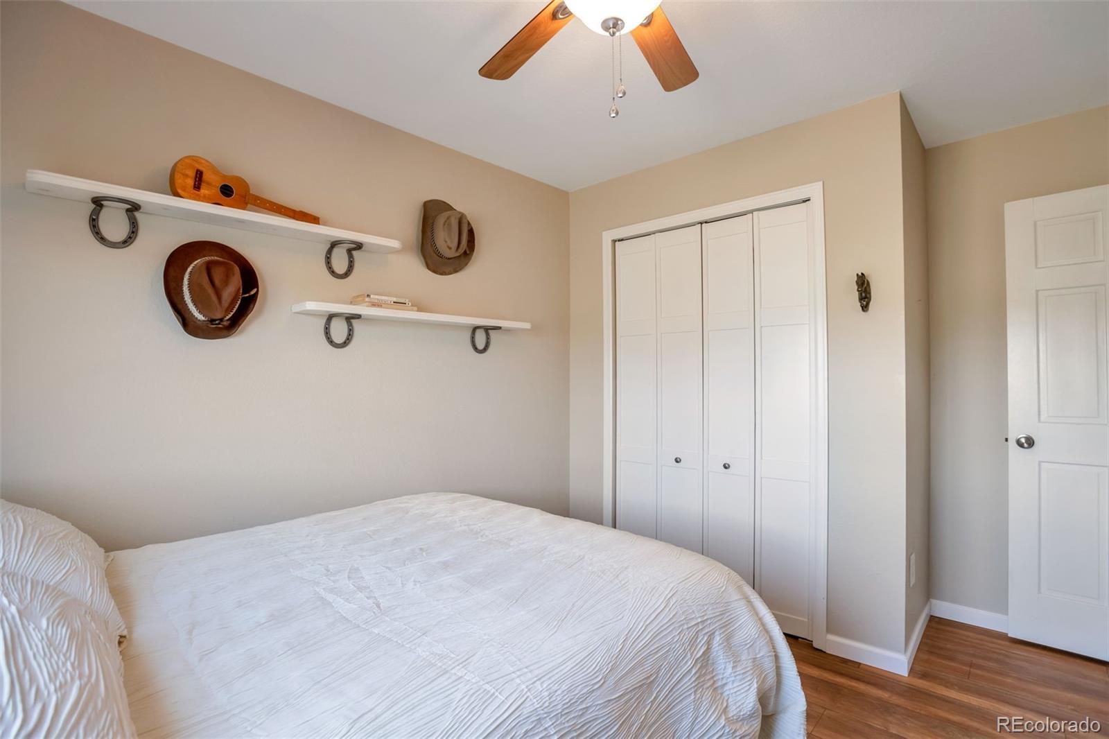 8678 Lariat Loop Elizabeth, CO 80107 - Photo 27 of 50 a bedroom with a bed and a chandelier