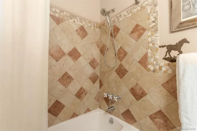 a bath tub sitting next to a white curtain