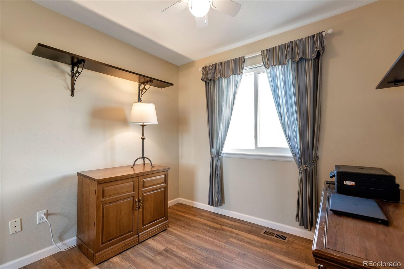 8678 Lariat Loop Elizabeth, CO 80107 - Photo 30 of 50 a view of a room with wooden floor and windows
