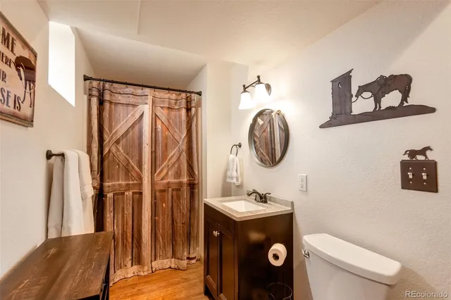 a bathroom with a toilet a sink and a mirror