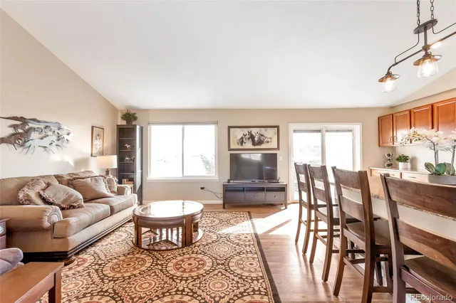 a living room with furniture wooden floor and a table