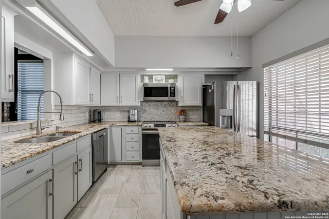 a kitchen with a sink stove and refrigerator