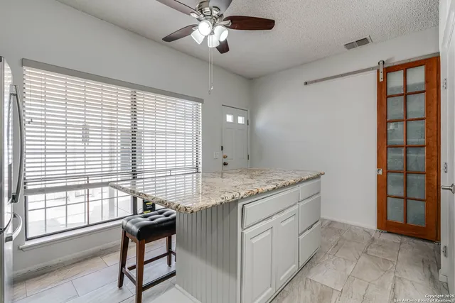 a view of a kitchen with a sink and cabinets