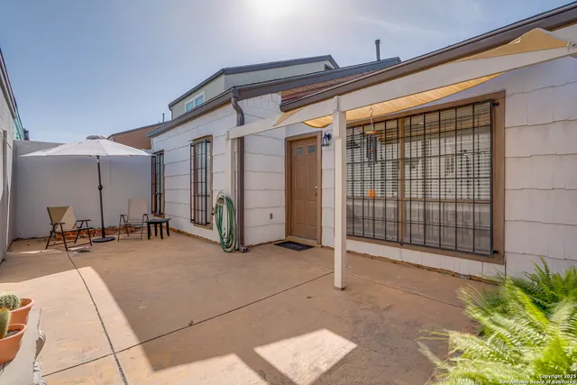 a view of a patio with table and chairs and potted plants
