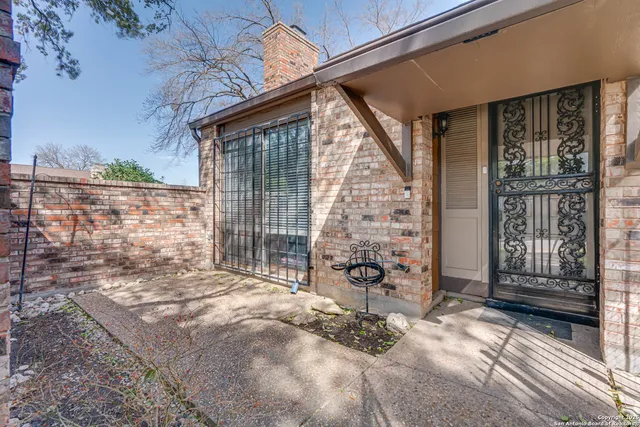 a view of a porch with a floor to ceiling window and wooden fence