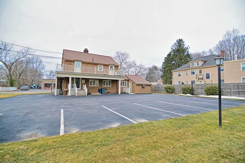 1068 Main Street, Unit 2 Walpole, MA 02081 - Photo 2 of 4 a view of a house with a yard