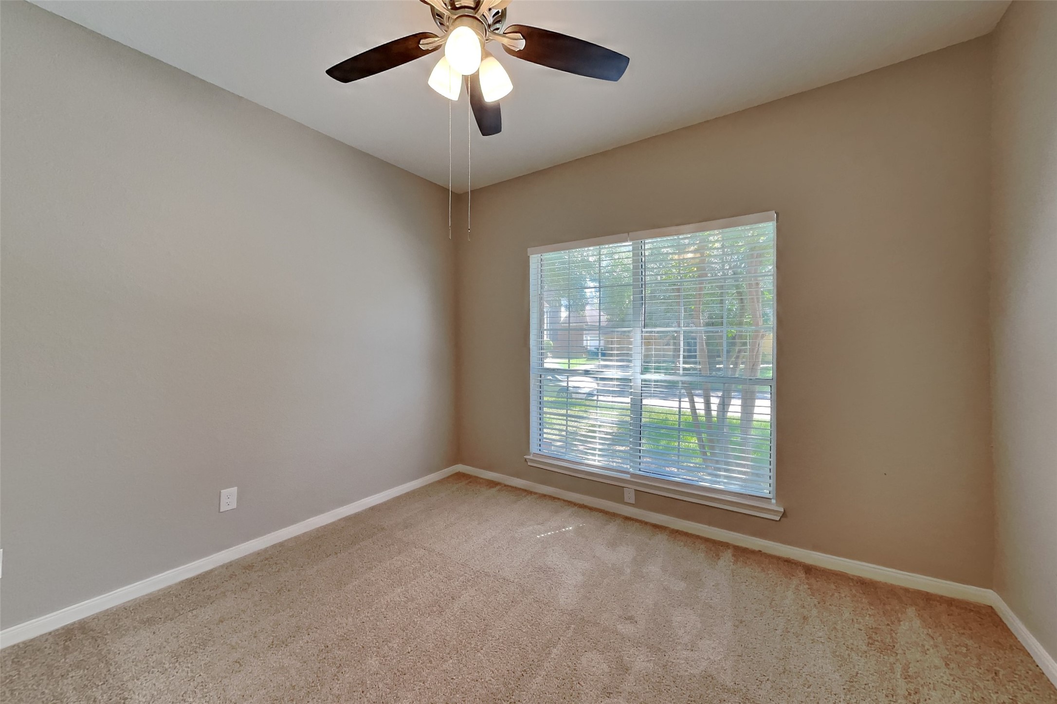 8615 Mile Run Road Humble, TX 77346 - Photo 13 of 19 an empty room with a ceiling fan and window