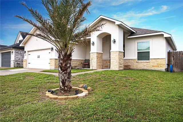 a front view of a house with a yard