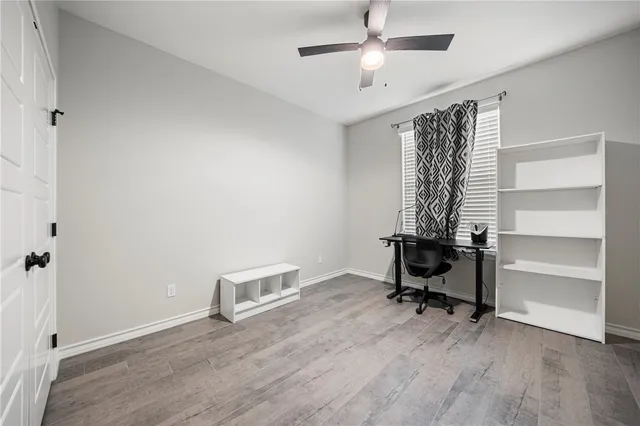 a view of room with wooden floor and windows