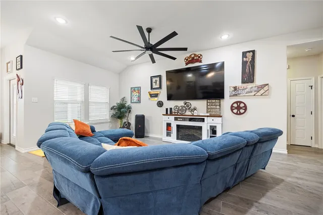 a living room with furniture and a flat screen tv