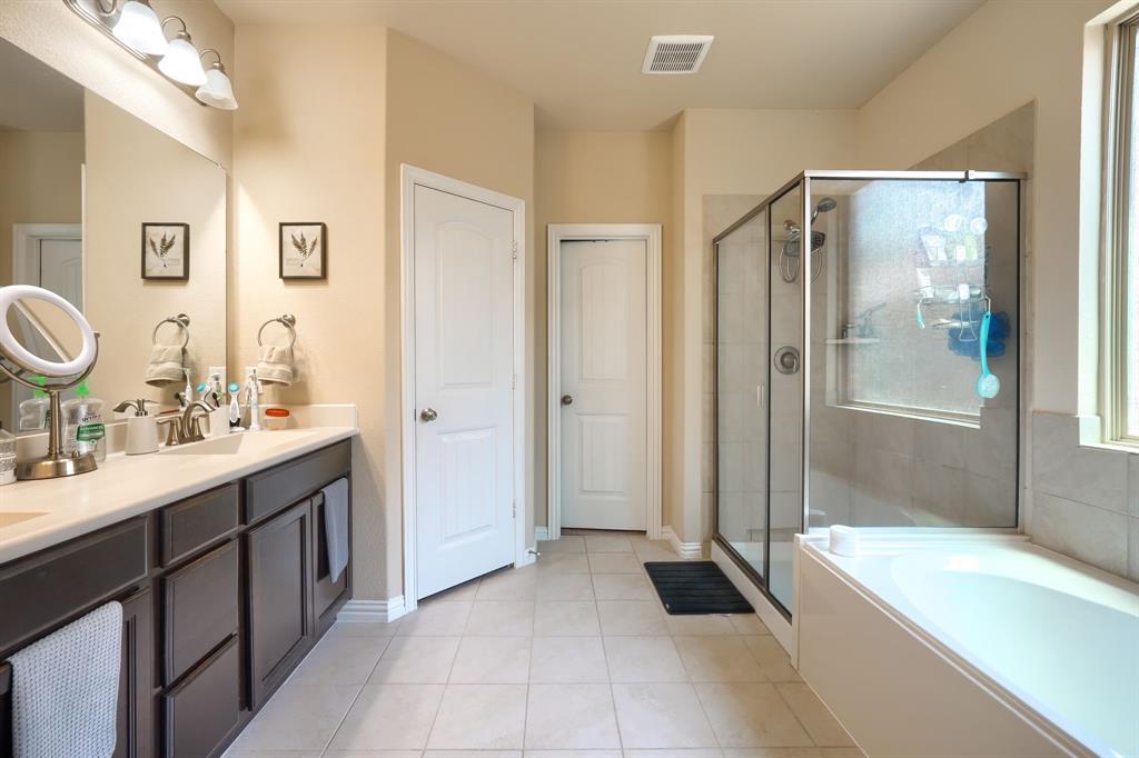 12417 Hitch Rack Way McKinney, TX 75071 - Photo 13 of 17 Bathroom with tile floors, separate shower and tub, and vanity