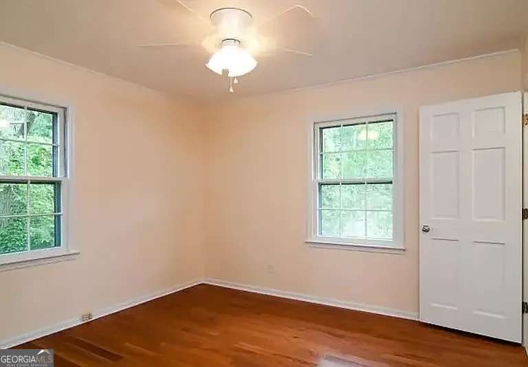 110 South Homewood Drive Athens, GA 30606 - Photo 14 of 21 an empty room with wooden floor and windows