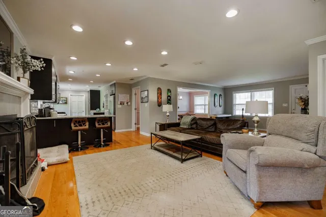 a living room with furniture and kitchen view