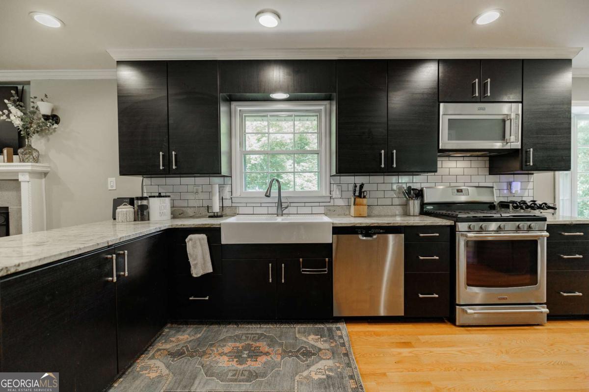 110 South Homewood Drive Athens, GA 30606 - Photo 9 of 21 a kitchen with a sink and a stove