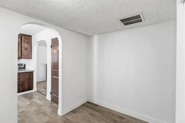 an empty room with closet and a chandelier fan