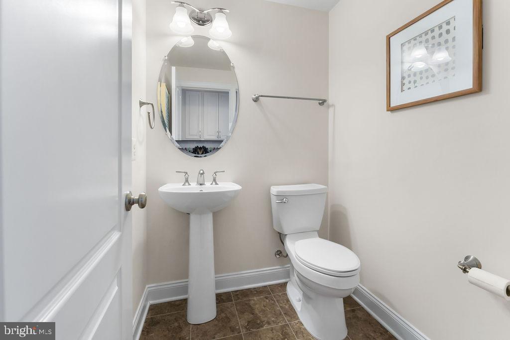 7608 Elmcrest Road Hanover, MD 21076 - Photo 12 of 41 a bathroom with a toilet a sink and mirror