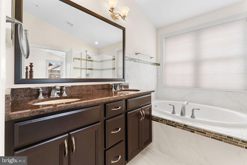 7608 Elmcrest Road Hanover, MD 21076 - Photo 22 of 41 a bathroom with a tub sink and mirror