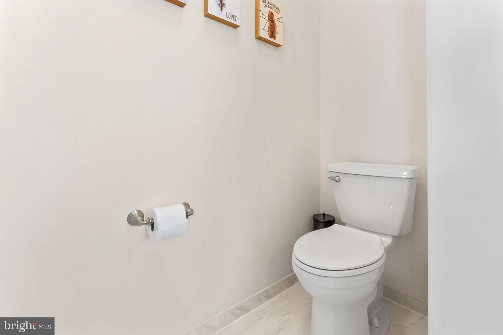 7608 Elmcrest Road Hanover, MD 21076 - Photo 24 of 41 a white toilet sitting next to a white wall
