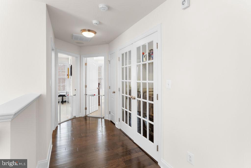 7608 Elmcrest Road Hanover, MD 21076 - Photo 25 of 41 a hallway with wooden floor windows and stairs