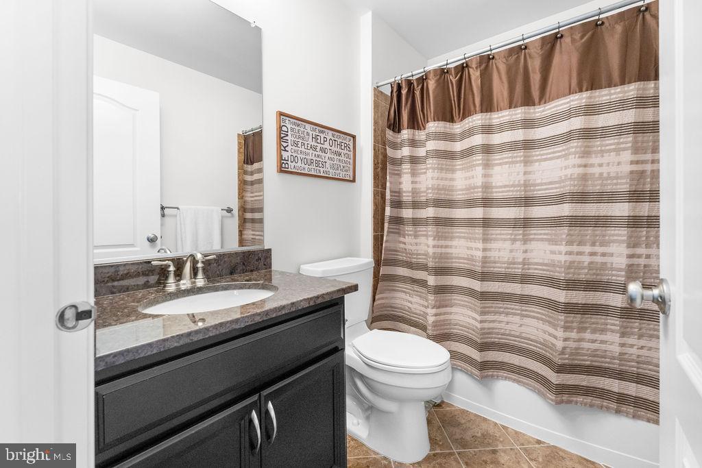 7608 Elmcrest Road Hanover, MD 21076 - Photo 28 of 41 a bathroom with a granite countertop sink toilet and shower