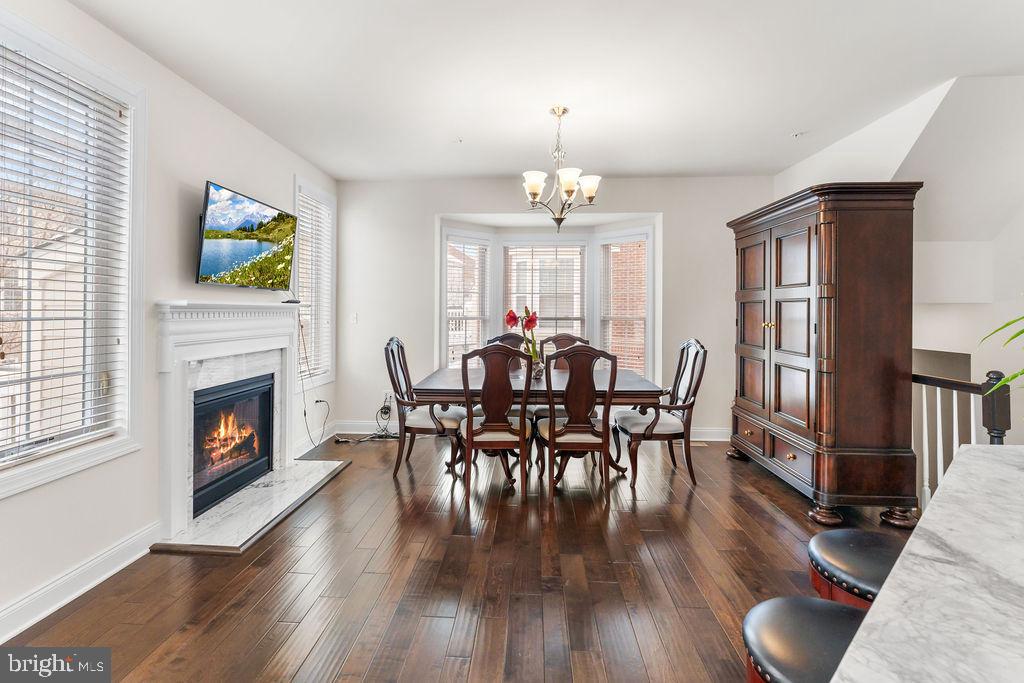 7608 Elmcrest Road Hanover, MD 21076 - Photo 6 of 41 a view of a dining room with furniture wooden floor and chandelier