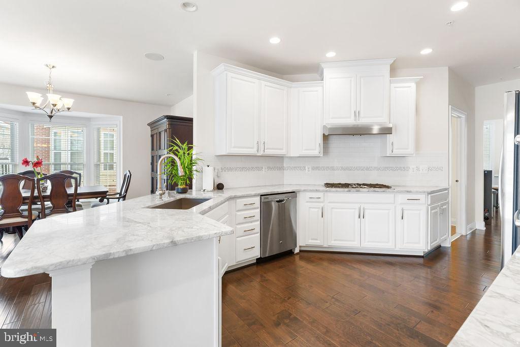7608 Elmcrest Road Hanover, MD 21076 - Photo 7 of 41 a kitchen with granite countertop a sink stainless steel appliances and cabinets