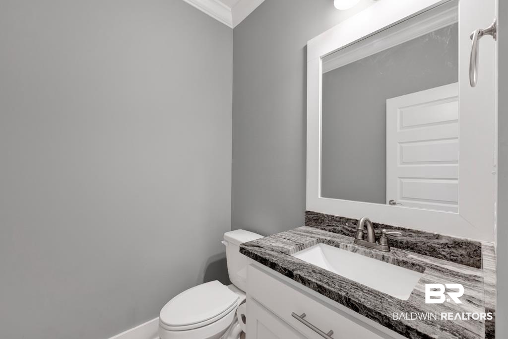 379 Pecan Ridge Boulevard Fairhope, AL 36532 - Photo 17 of 21 Bathroom featuring a white vanity with brushed nickel hardware, a rectangular undermount sink, and a gray patterned countertop