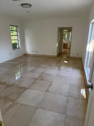 a bathroom with a sink and mirror with bathtub
