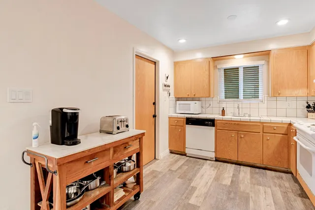 a kitchen with stainless steel appliances granite countertop a stove and a sink