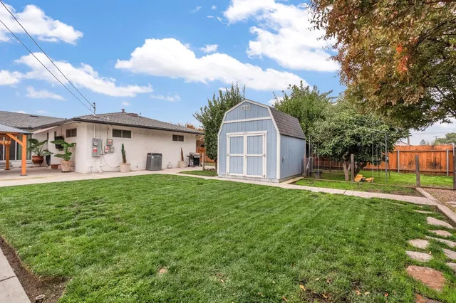 a garden with plants and wooden fence