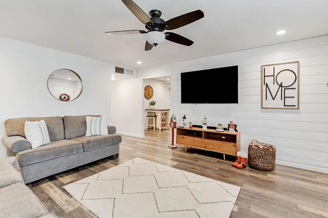 a living room with furniture and a flat screen tv