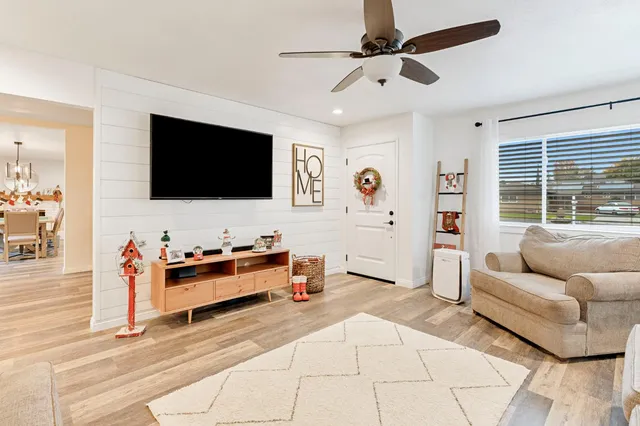 a living room with furniture and a flat screen tv
