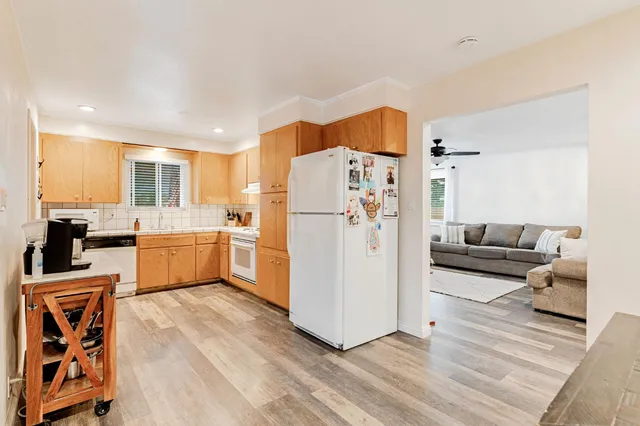 a kitchen with stainless steel appliances a refrigerator sink and cabinets