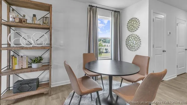 a dining room with furniture and window