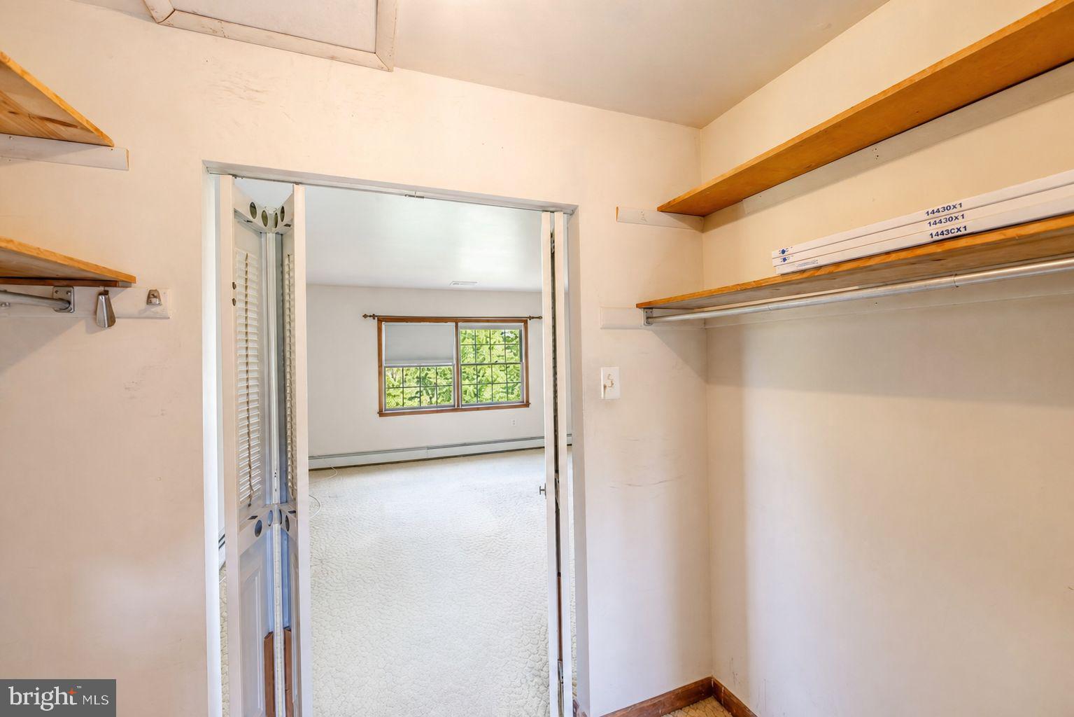 223 Trythall Road Elverson, PA 19520 - Photo 42 of 78 a view of a closet area with wooden floor